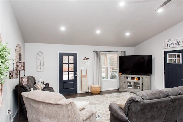 living area featuring lofted ceiling, dark wood-type flooring, and recessed lighting