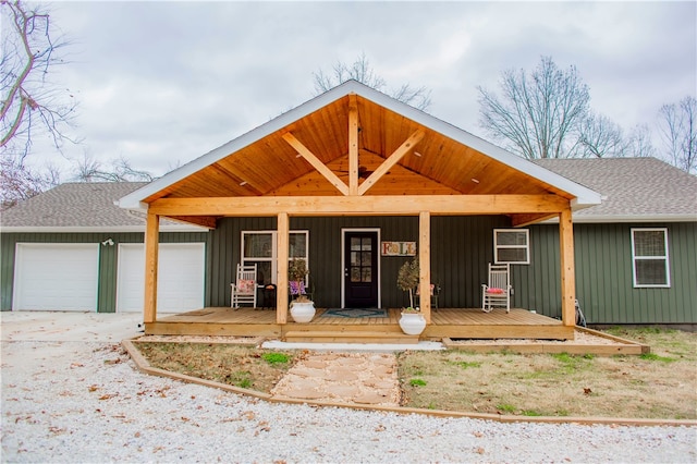 view of front of home with a porch and a garage