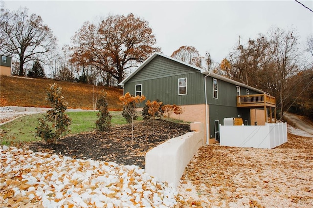 view of side of property featuring a deck