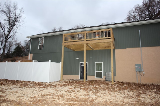 back of property featuring central AC unit and a deck