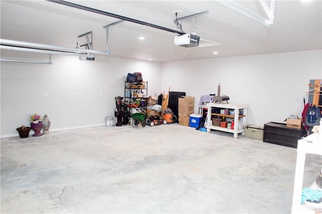 garage with recessed lighting and a garage door opener