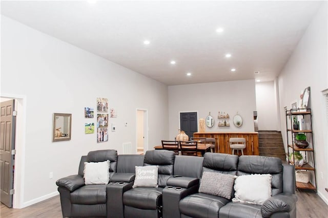 cinema room featuring baseboards, recessed lighting, and light wood-style floors