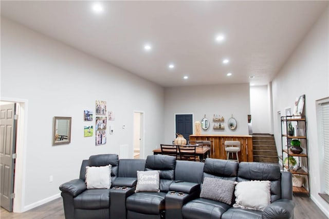 home theater room featuring baseboards, wood finished floors, and recessed lighting