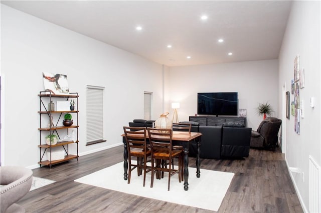 dining area with baseboards, dark wood-type flooring, and recessed lighting