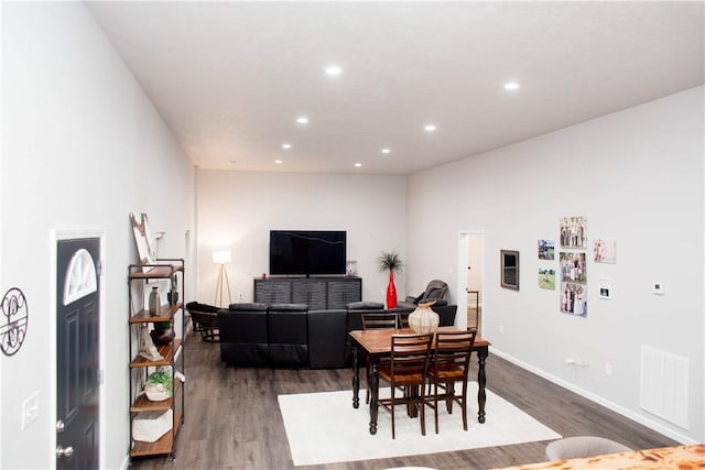 dining room with dark wood-style floors, baseboards, visible vents, and recessed lighting