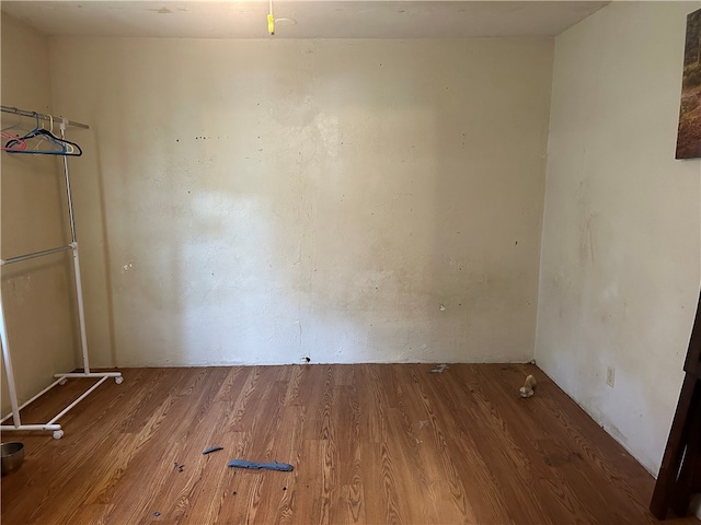 empty room with hardwood / wood-style flooring