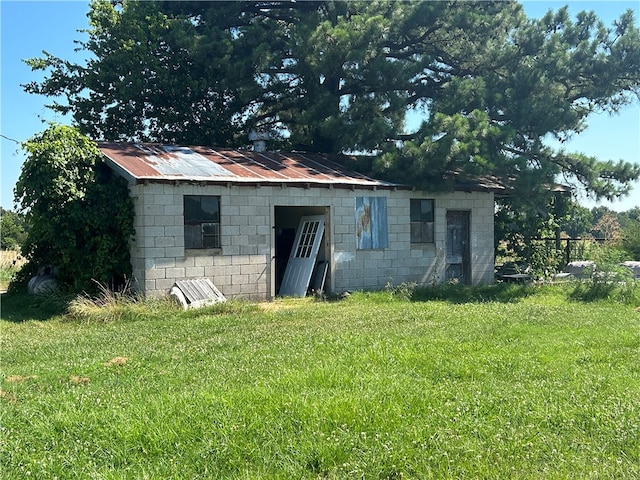 view of outbuilding featuring a yard