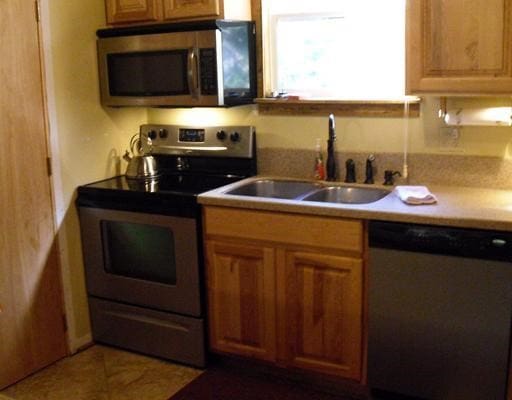 kitchen featuring appliances with stainless steel finishes and sink