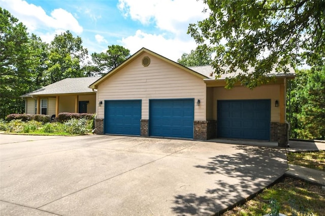 single story home with an attached garage, concrete driveway, and brick siding