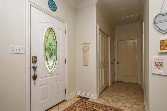 entrance foyer featuring baseboards, light tile patterned flooring, visible vents, and crown molding