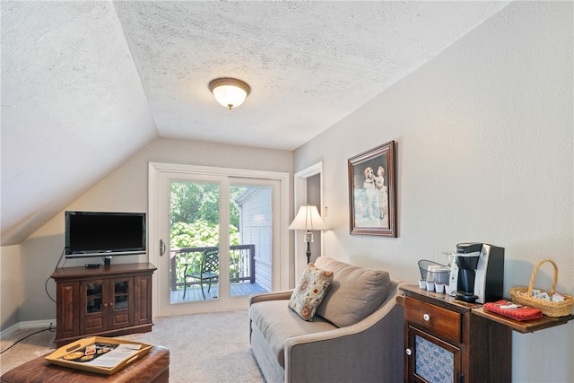 carpeted living room featuring lofted ceiling and a textured ceiling