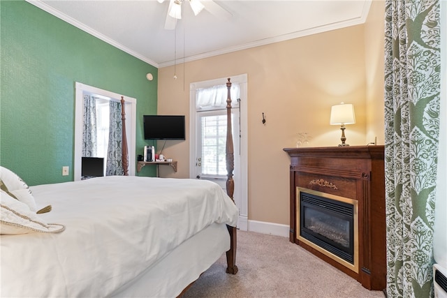 carpeted bedroom with crown molding and ceiling fan