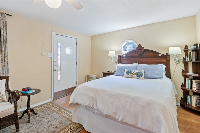 bedroom with ceiling fan and hardwood / wood-style floors