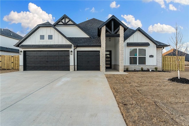 modern inspired farmhouse with driveway, fence, board and batten siding, a shingled roof, and a garage