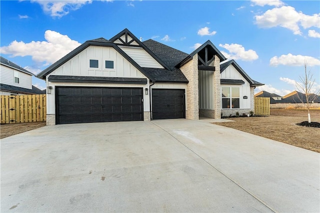 modern farmhouse featuring fence, roof with shingles, board and batten siding, concrete driveway, and an attached garage