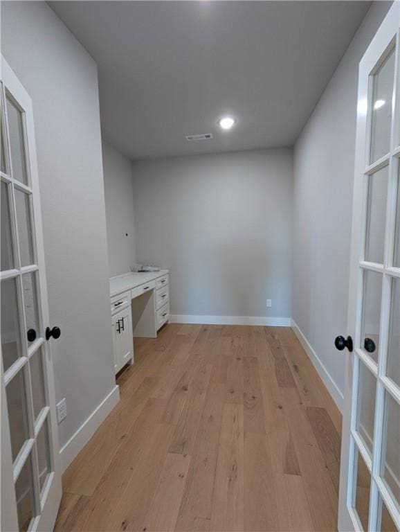 interior space featuring french doors and light hardwood / wood-style floors