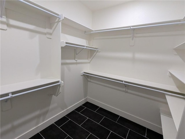 spacious closet with dark tile patterned flooring