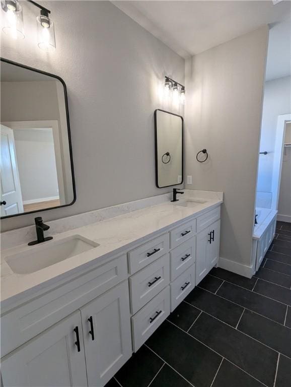 bathroom featuring vanity, a bathtub, and tile patterned flooring