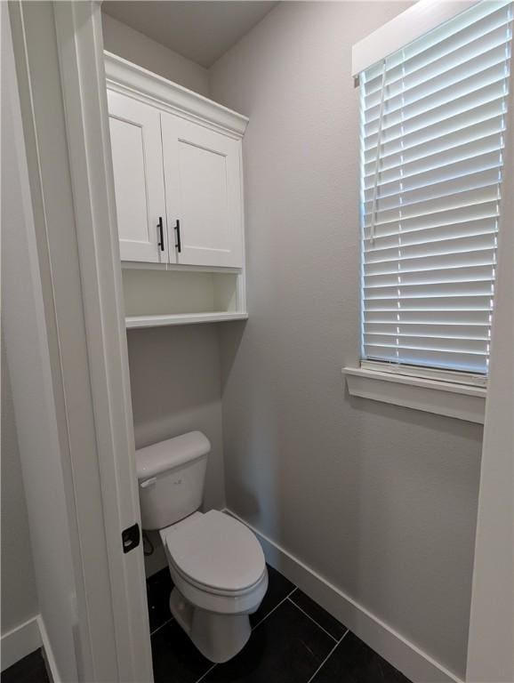 bathroom featuring tile patterned floors and toilet