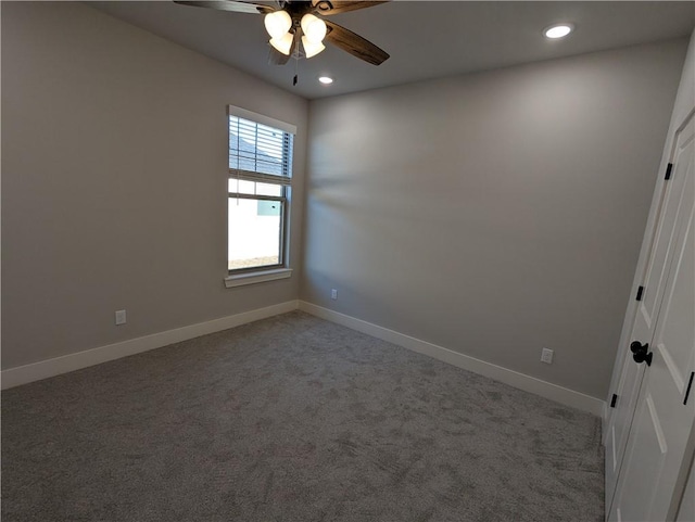 unfurnished room featuring ceiling fan and carpet