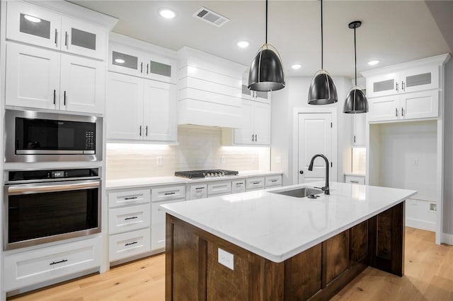 7843 Range Ave, Springdale, AR 72762 - kitchen featuring stainless steel appliances, a sink, light wood finished floors, an island with sink, and recessed lighting