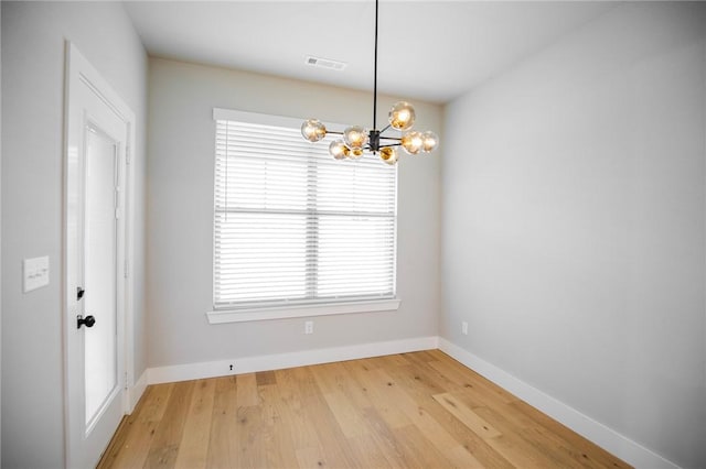 7843 Range Ave, Springdale, AR 72762 - unfurnished room featuring a chandelier, baseboards, and light wood finished floors