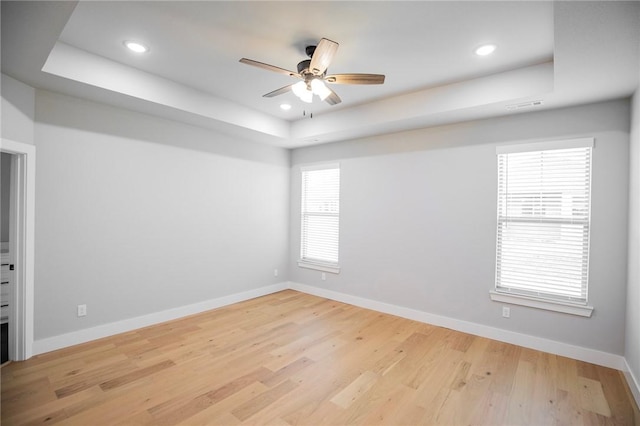 7843 Range Ave, Springdale, AR 72762 - unfurnished room featuring a tray ceiling, a ceiling fan, baseboards, light wood-type flooring, and recessed lighting