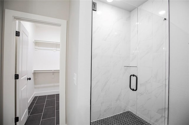 7843 Range Ave, Springdale, AR 72762 - bathroom with a marble finish shower, a walk in closet, and tile patterned floors