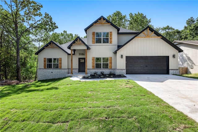 modern farmhouse featuring a front lawn, concrete driveway, brick siding, and an attached garage