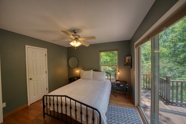 bedroom featuring access to outside, hardwood / wood-style floors, and ceiling fan