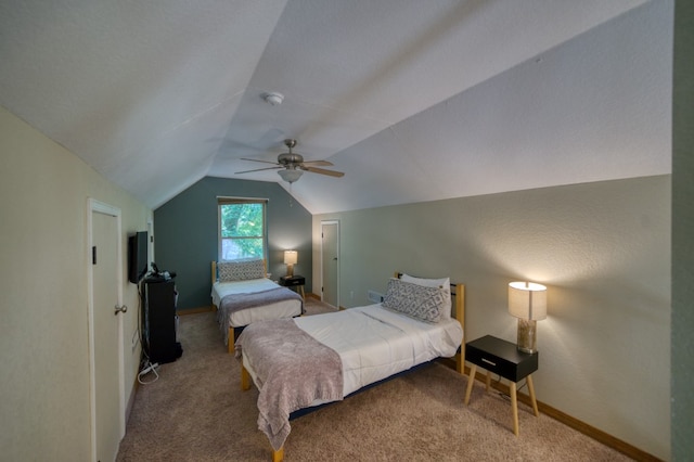 carpeted bedroom with vaulted ceiling and ceiling fan