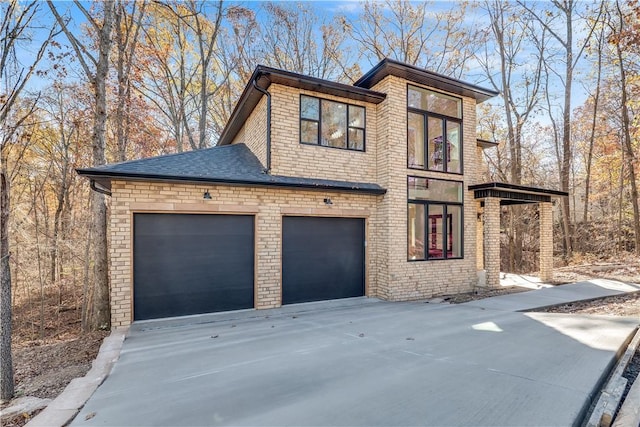 view of side of home featuring driveway and an attached garage