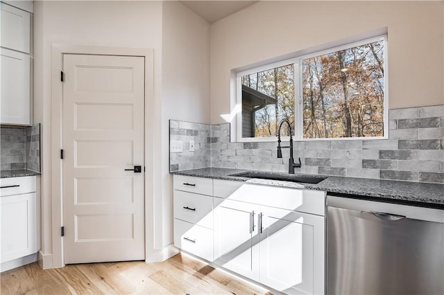 kitchen with dishwasher, light wood-type flooring, a sink, and white cabinets