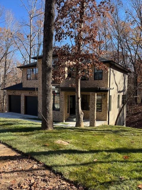 view of front of home with a garage and a front yard