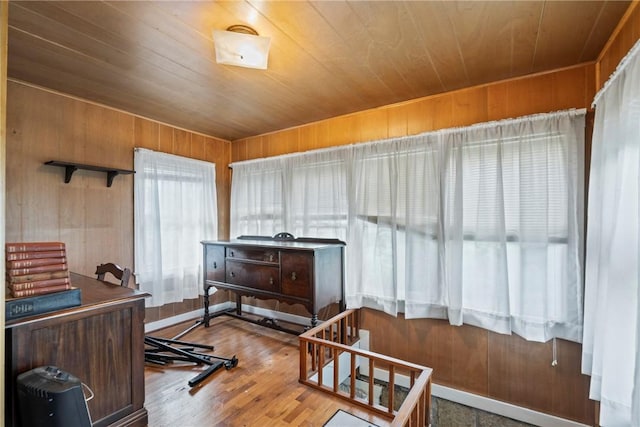 interior space with wood-type flooring, wooden walls, and wood ceiling