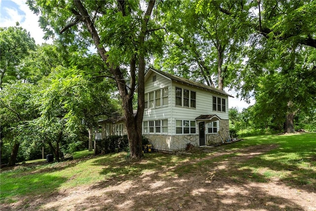 rear view of house with a yard