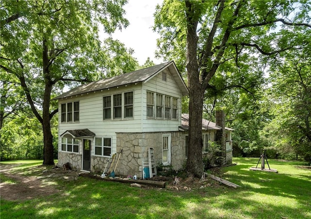 rear view of house with a lawn