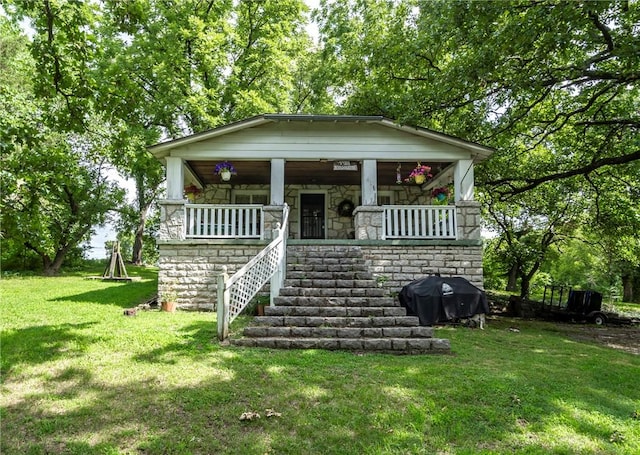 view of front of house with covered porch and a front yard