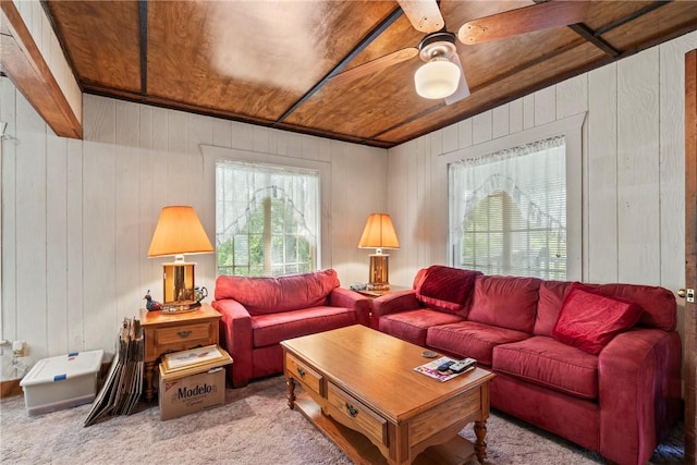 living room featuring wooden ceiling, light carpet, and wooden walls