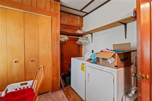 washroom with wooden walls, light hardwood / wood-style floors, and independent washer and dryer