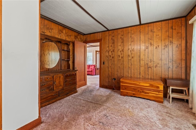 sitting room with wood walls and light carpet