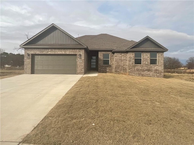 view of front of home with a garage and a front lawn