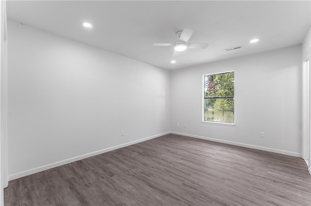 unfurnished room featuring ceiling fan and dark wood-type flooring