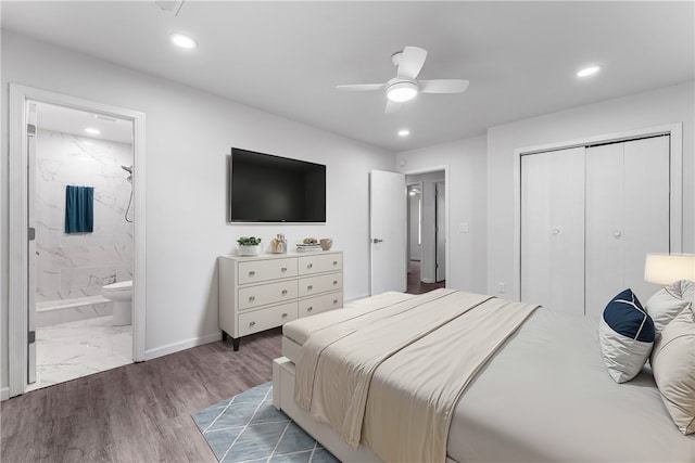 bedroom featuring ceiling fan, a closet, ensuite bath, and dark hardwood / wood-style floors