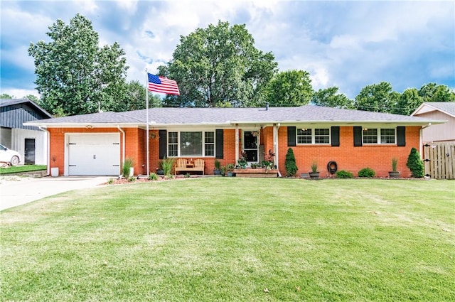 ranch-style home featuring covered porch, a garage, and a front lawn