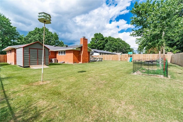 view of yard with central AC unit and a storage shed