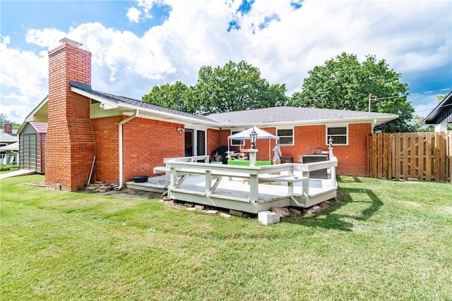 back of house with a yard and a wooden deck