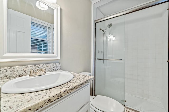 bathroom featuring vanity, toilet, and walk in shower