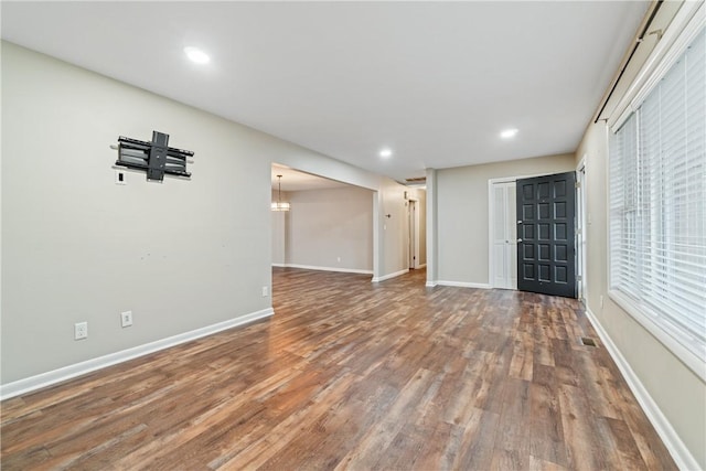 unfurnished living room with wood-type flooring