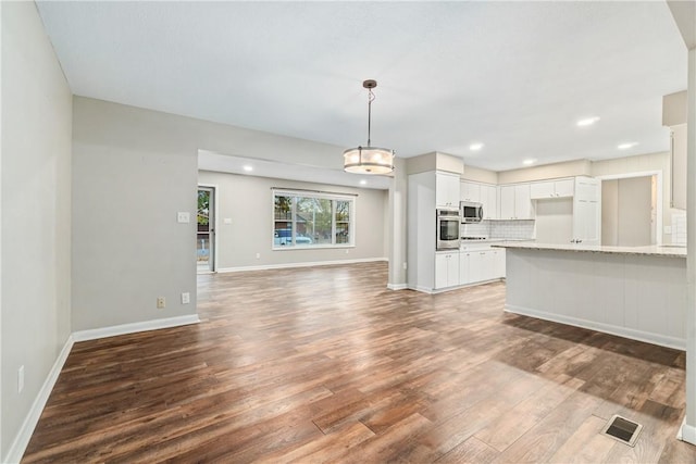 unfurnished living room featuring dark hardwood / wood-style floors